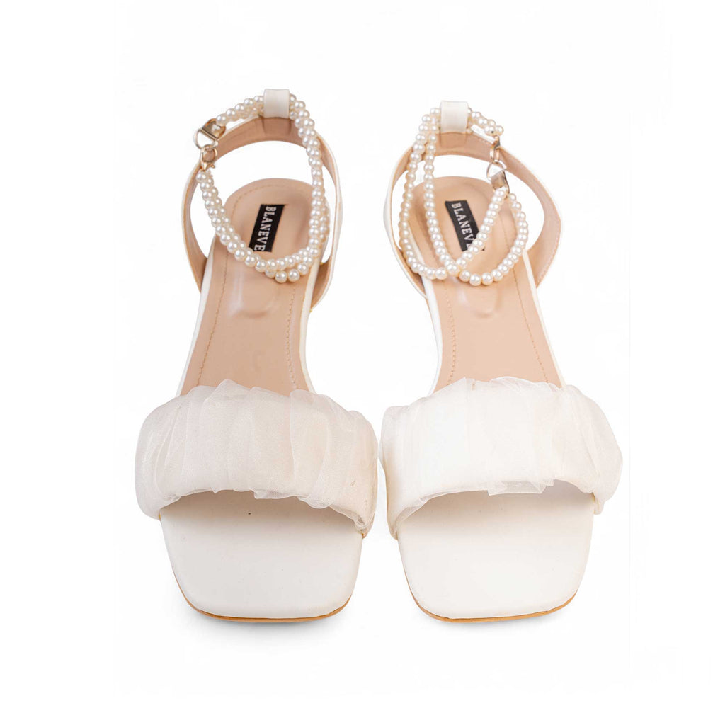 Front view of BLANEVE Meringue white sandals with gathered ruffle toe straps and pearl-beaded ankle straps.