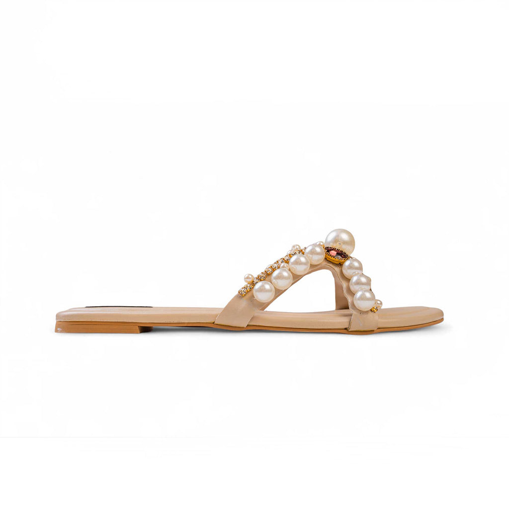 Side view of BLANEVE Reina cream flat slide with a pearl-embellished V-strap and gold-toned detailing