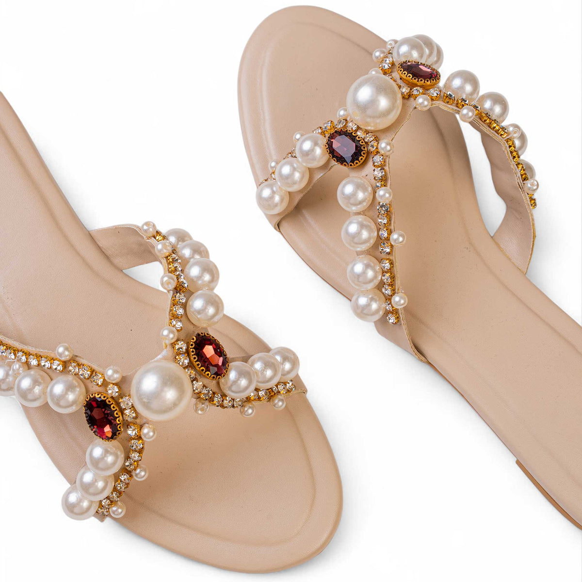 Close-up of pearls, rhinestones and oval gems in gold-toned settings on BLANEVE Reina cream slides