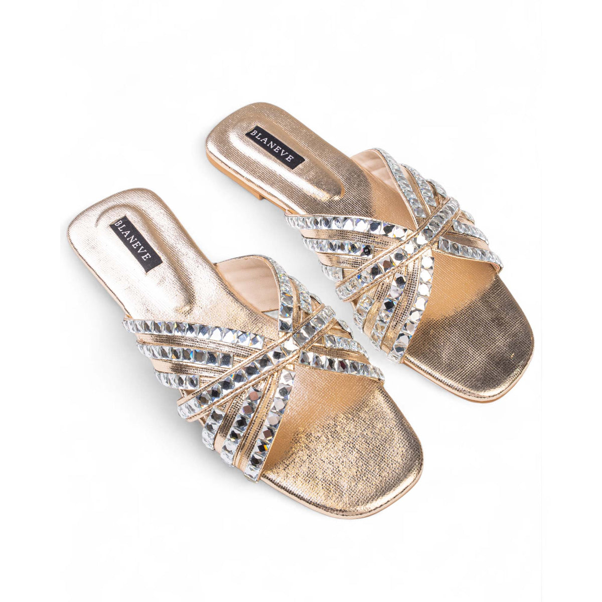 Angled view of BLANEVE Halo flat slides showing overlapping crystal-embellished straps and gold-toned footbeds