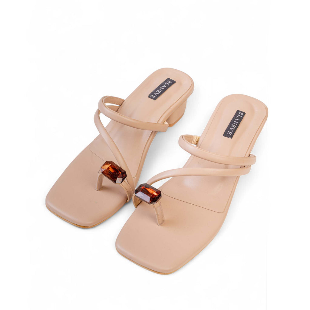 Angled view of BLANEVE Willow beige sandals showing toe-post stones, slim straps and low block heels.