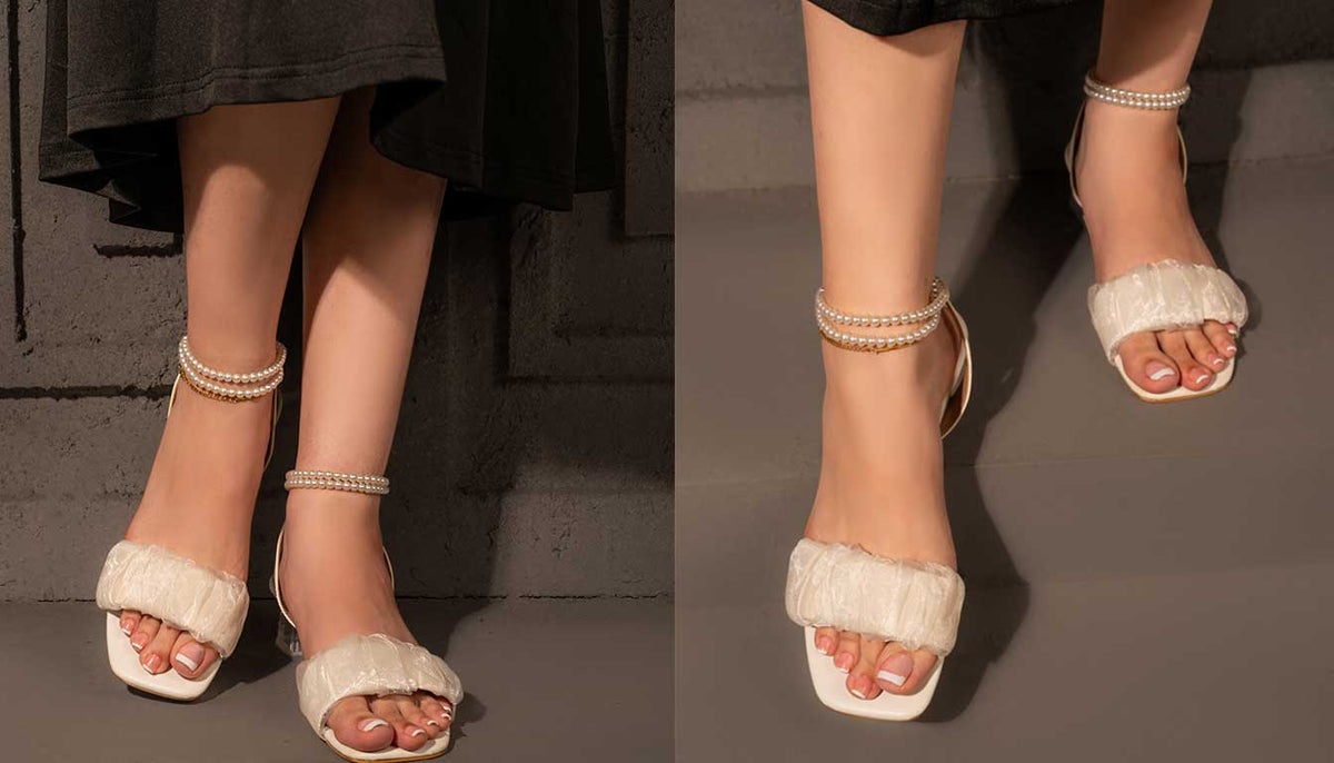 Two views of ivory sandals with fluffy front straps and pearl ankle straps, worn with a black outfit.